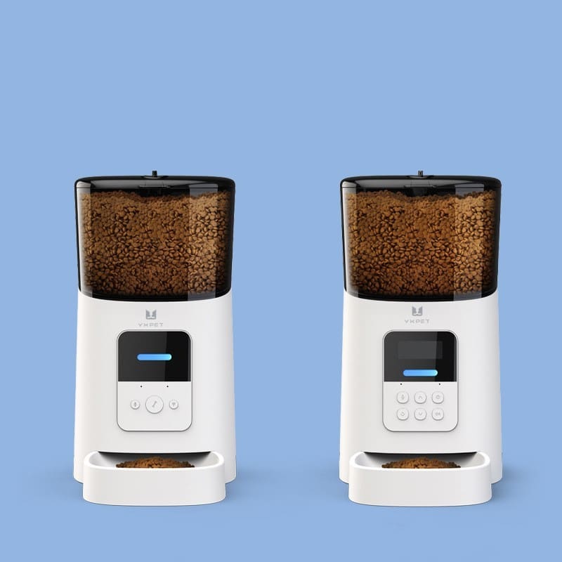 Two white automatic pet feeders with dry food.