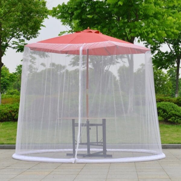 White mosquito net around patio table.