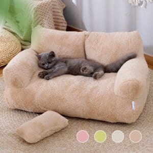 Grey cat resting on a plush sofa bed.