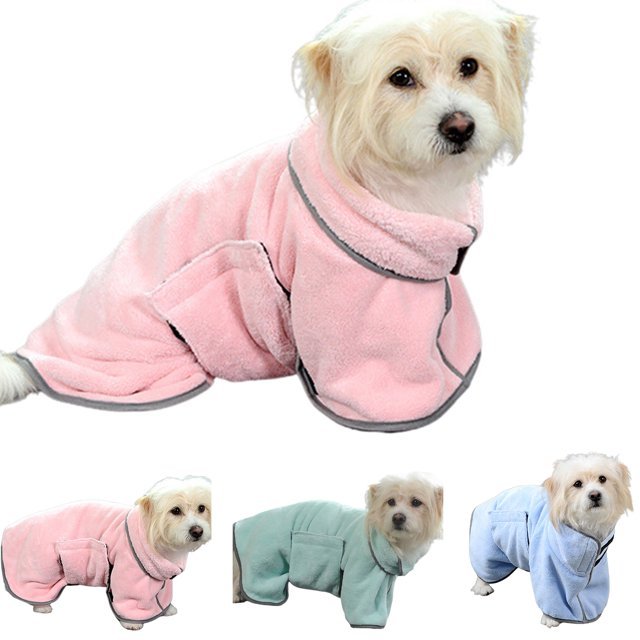 Three dogs wearing pink and blue towels.