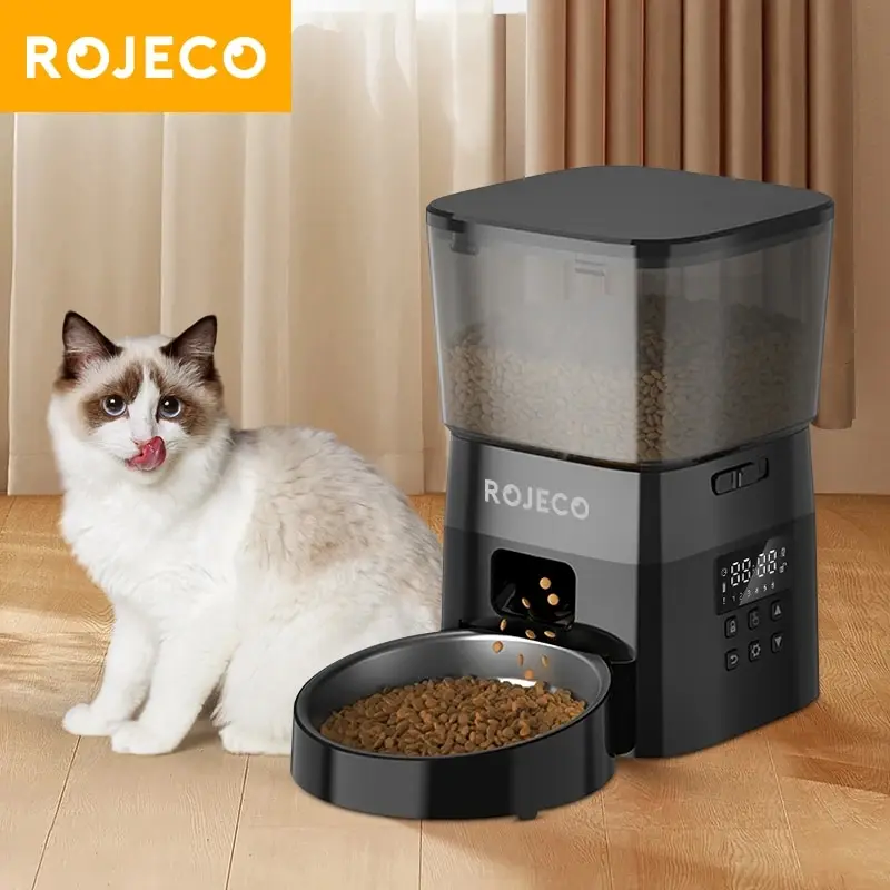 Cat eating from automatic pet feeder.