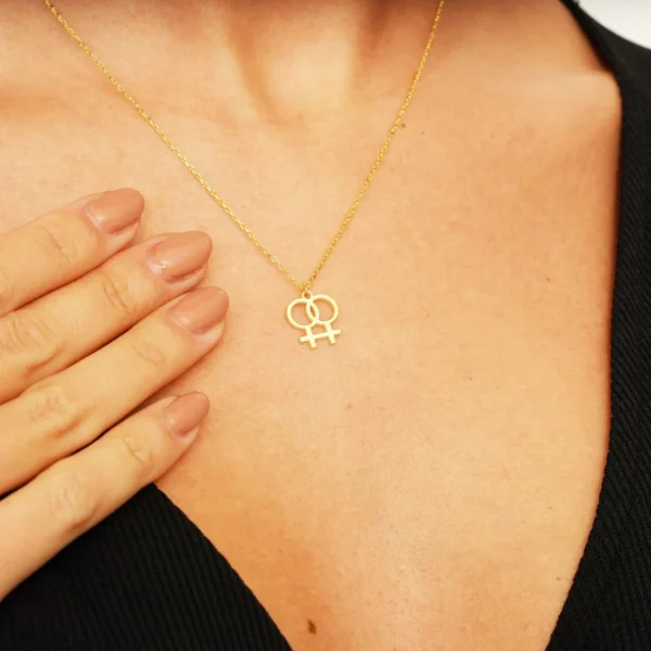 Gold necklace with lesbian symbol pendant.