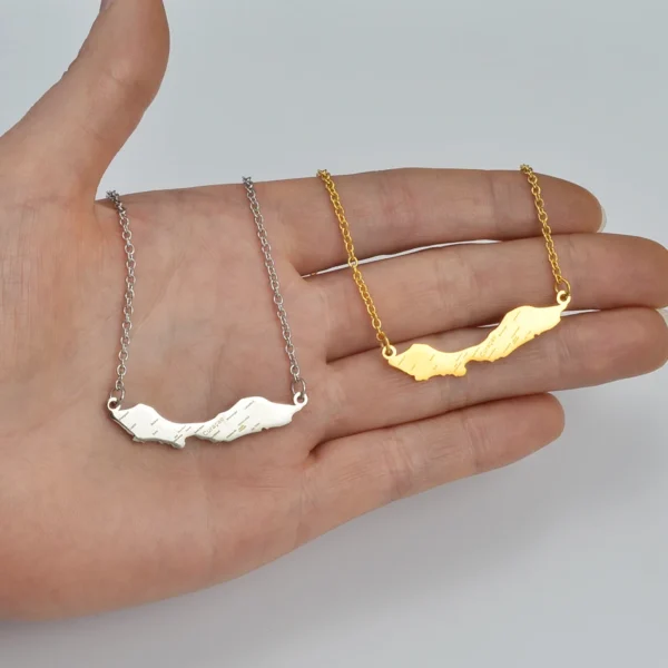 Silver and gold Curaao map necklaces.