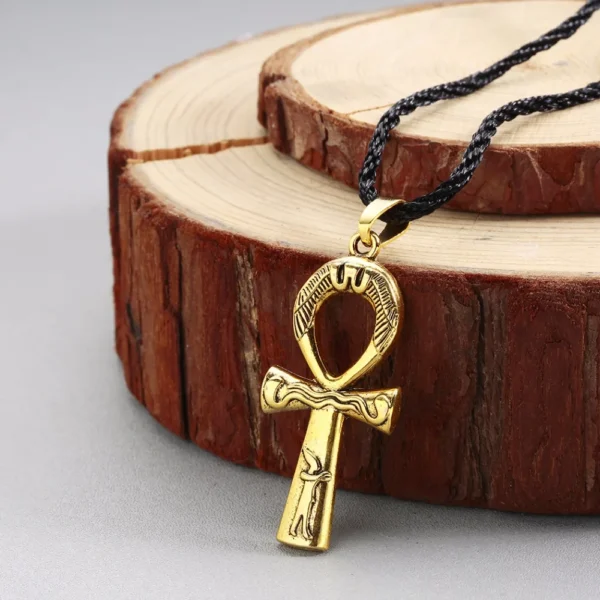 Gold Ankh pendant on black cord necklace.