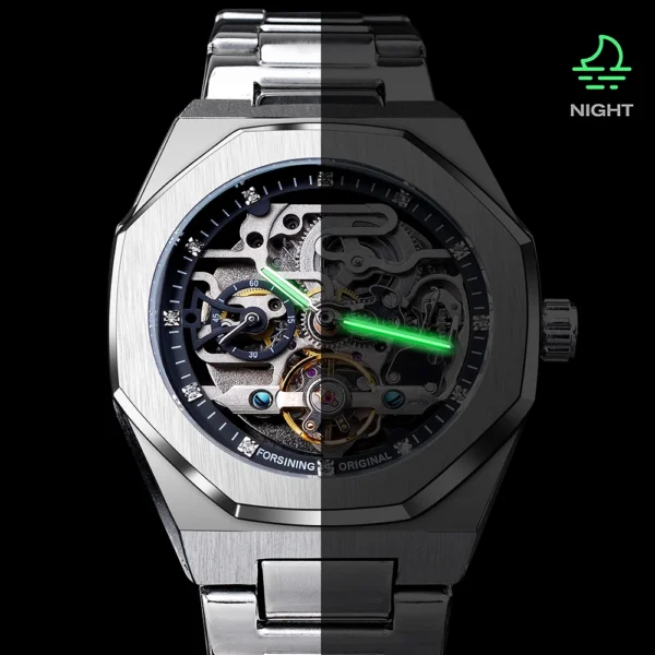 Silver automatic watch with green glow in the dark hands.