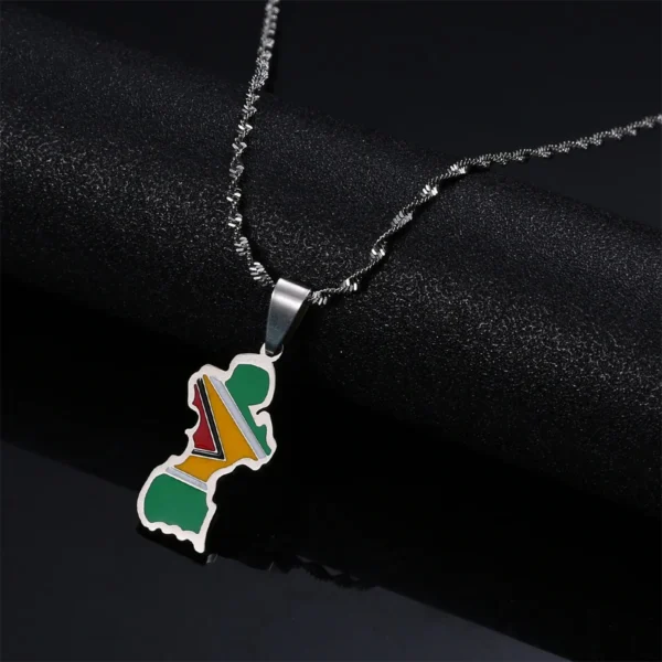 Guyana flag pendant necklace on black background.