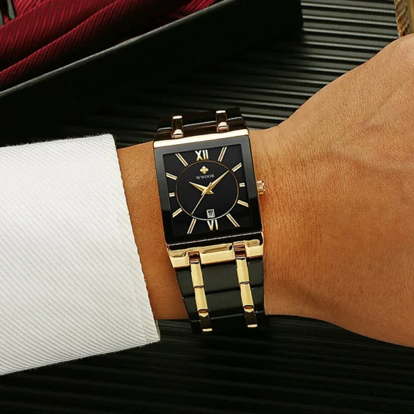 Black and gold square wristwatch on wrist.