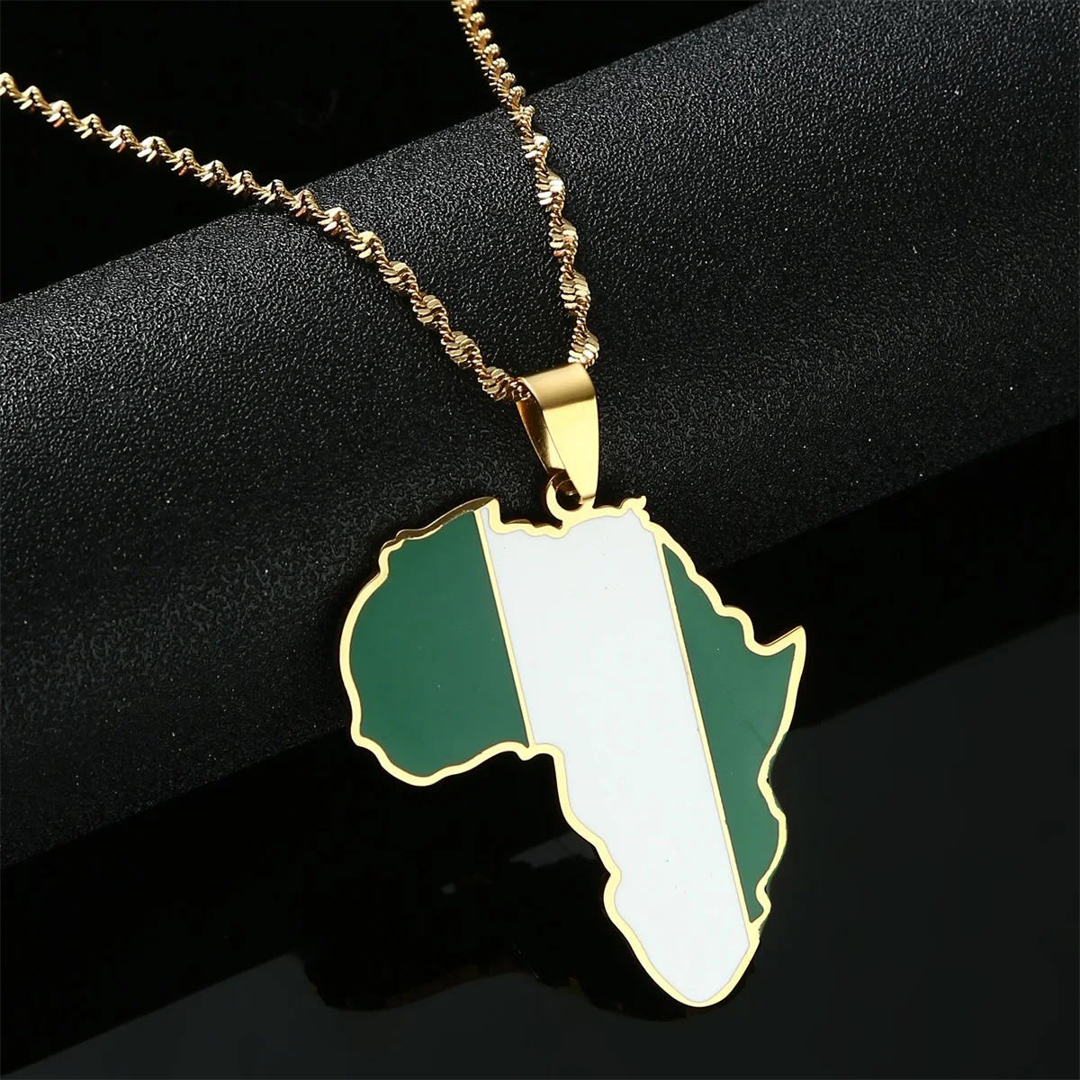 Gold necklace with Nigerian flag pendant.