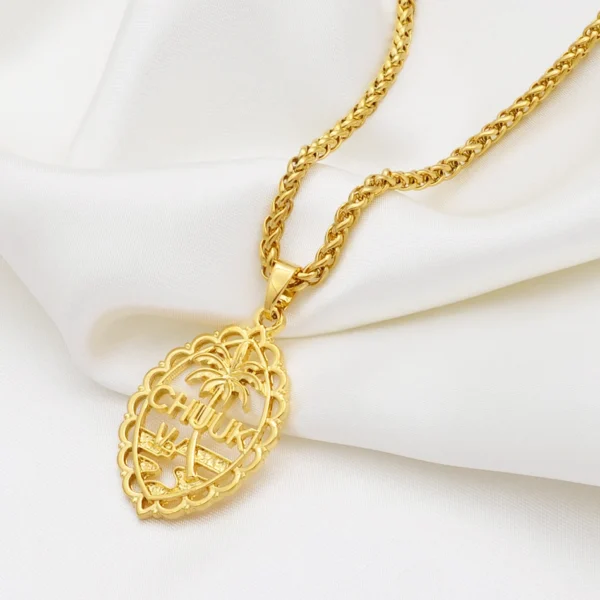 Gold necklace with a Fiji pendant.