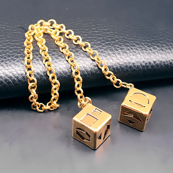 Gold chain with two dice charms.