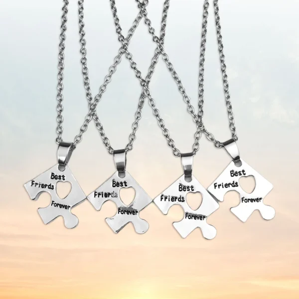 Four silver necklaces with heart puzzle pendants.