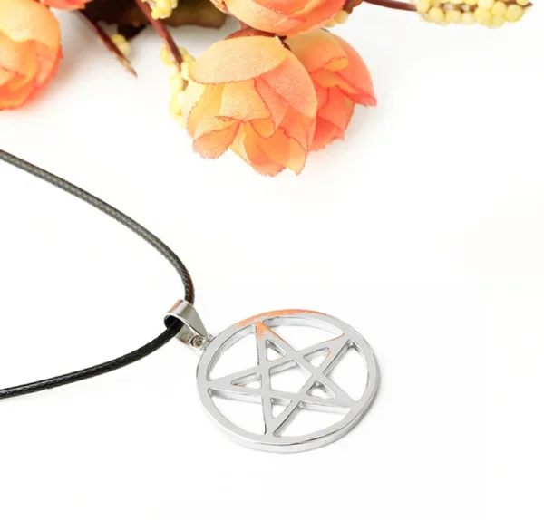 Silver pentagram pendant necklace on black cord.