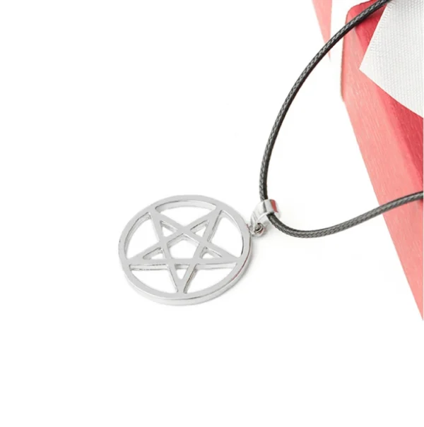 Silver pentagram necklace on black cord.