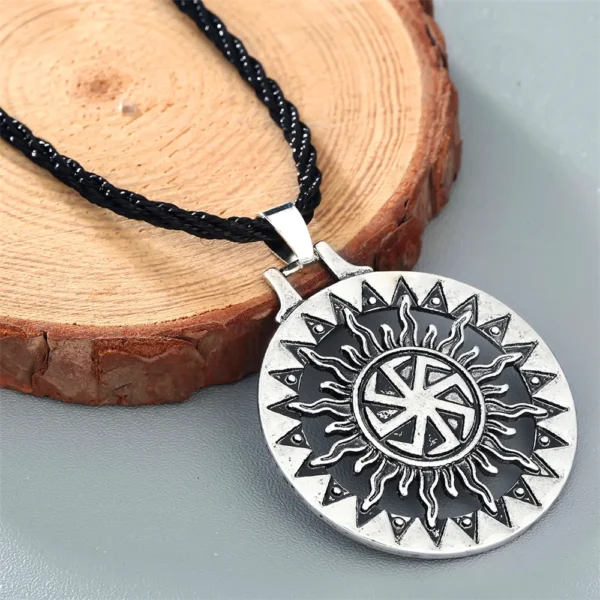 Silver necklace with sun symbol pendant.