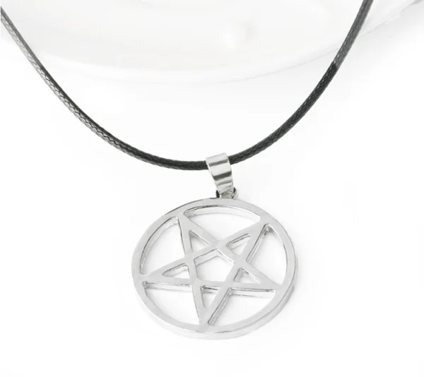 Silver pentagram pendant on black cord necklace.