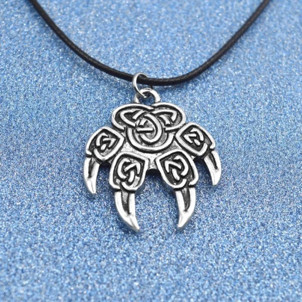 Silver Celtic knot paw print necklace.