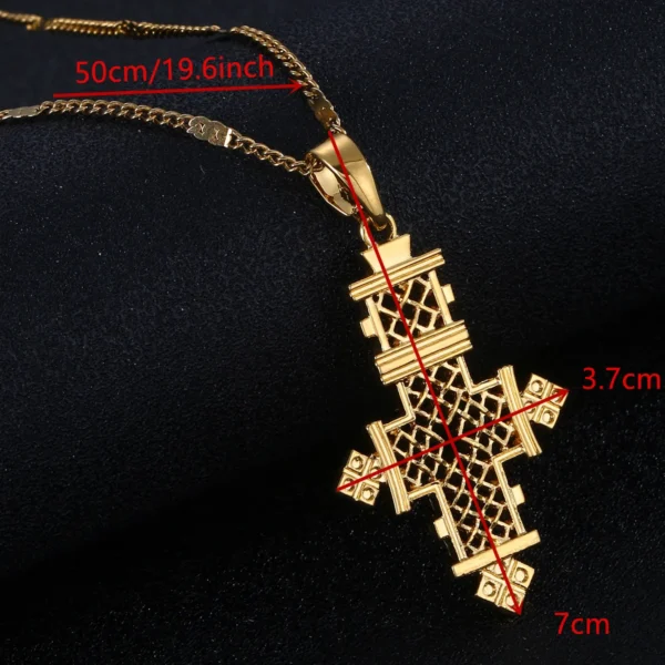 Gold cross pendant necklace on black background.