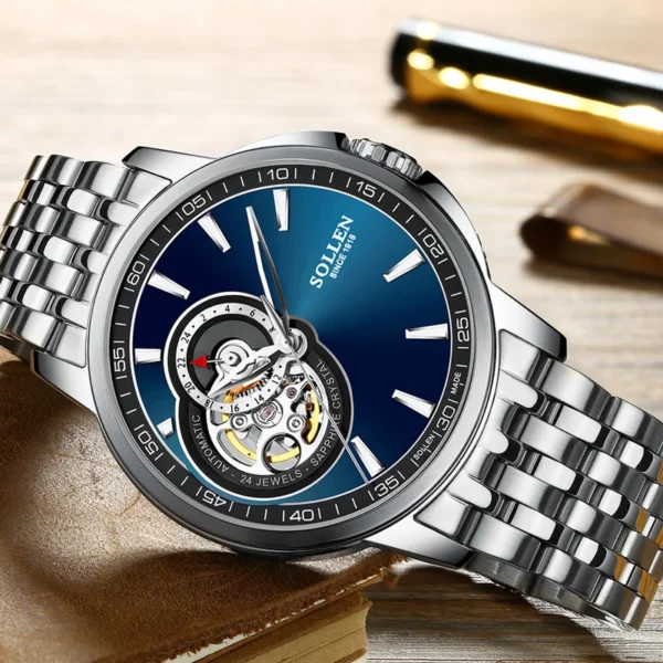 Silver watch with blue face and open heart mechanism.