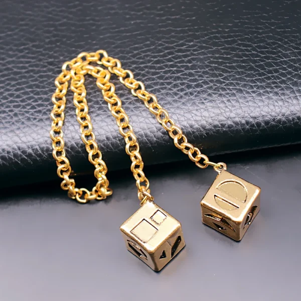 Gold chain with two dice charms.