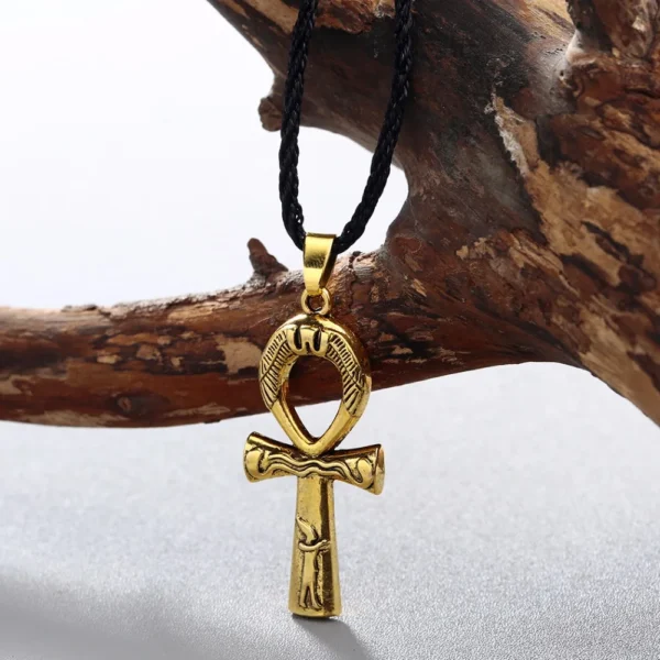 Gold ankh pendant on black cord necklace.