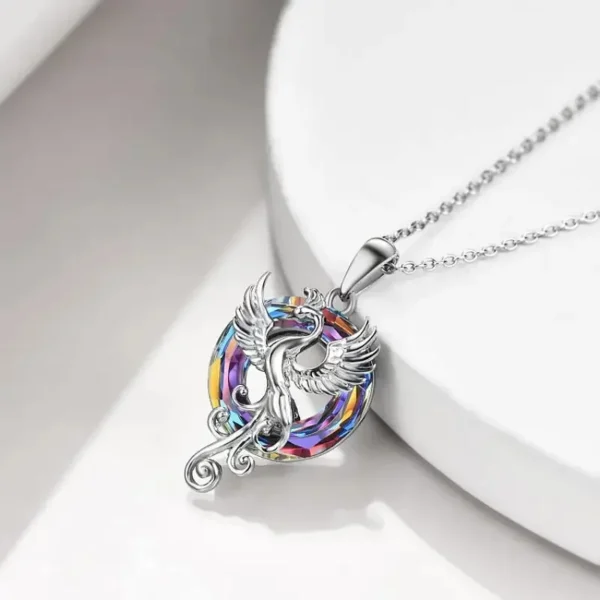 Silver necklace with iridescent phoenix pendant.