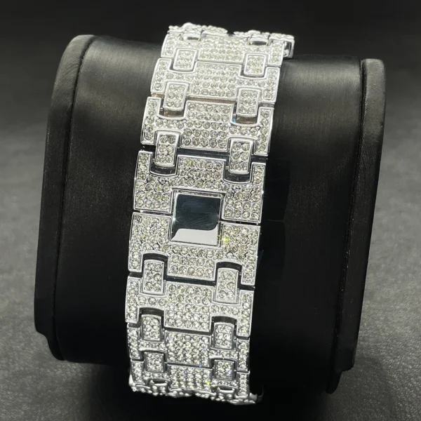 Diamond-encrusted watch band on black surface.