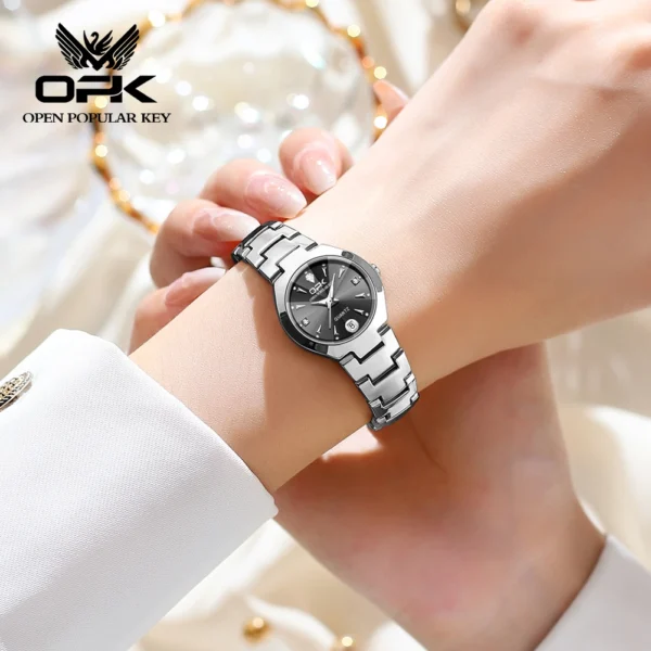 Woman wearing silver and black wristwatch.