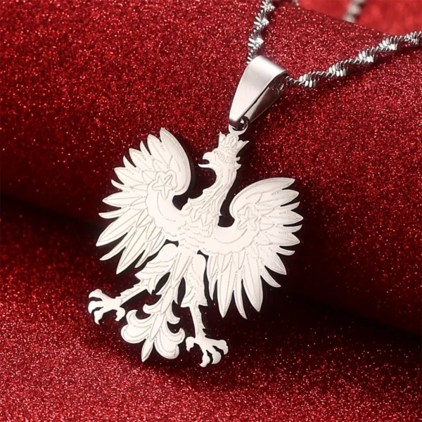 Silver eagle pendant necklace on red background.