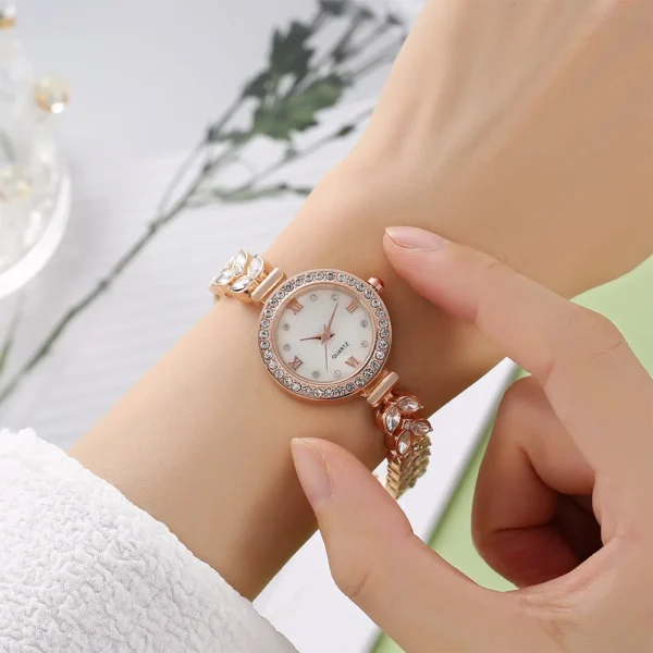 Rose gold watch with crystal accents.