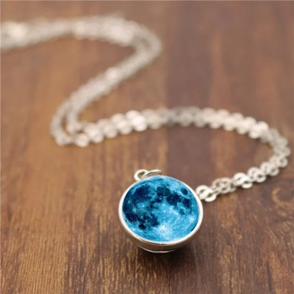 Silver necklace with blue moon pendant.