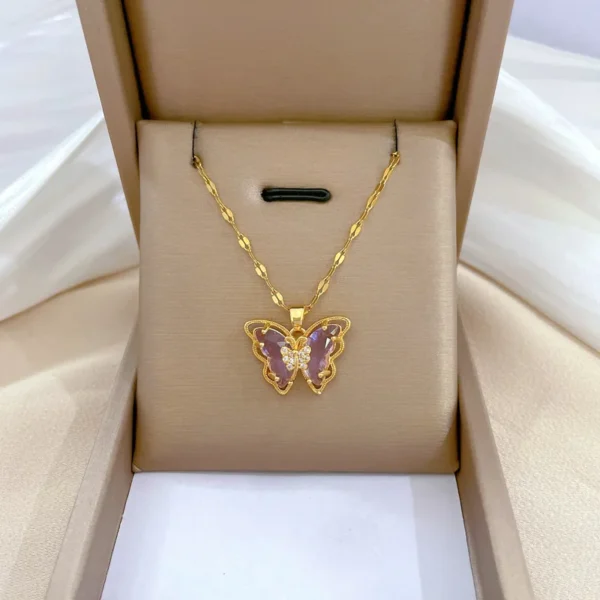 Gold necklace with purple butterfly pendant.