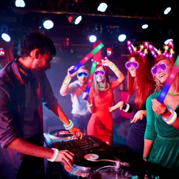 DJ mixing music with glow sticks and friends.