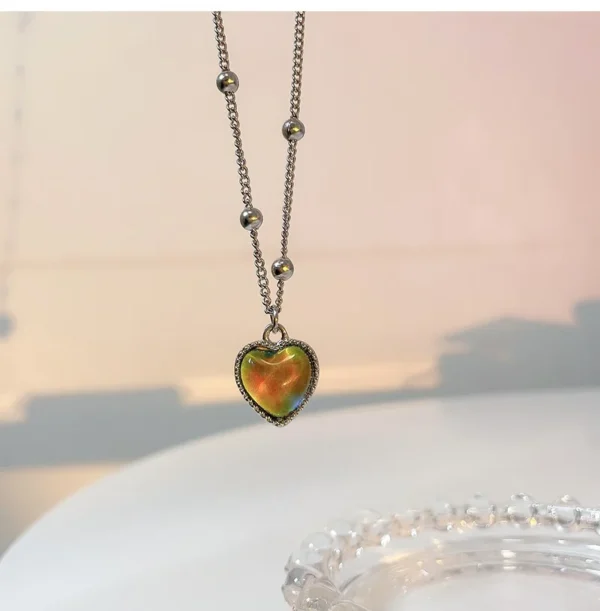 Silver chain necklace with a heart pendant.