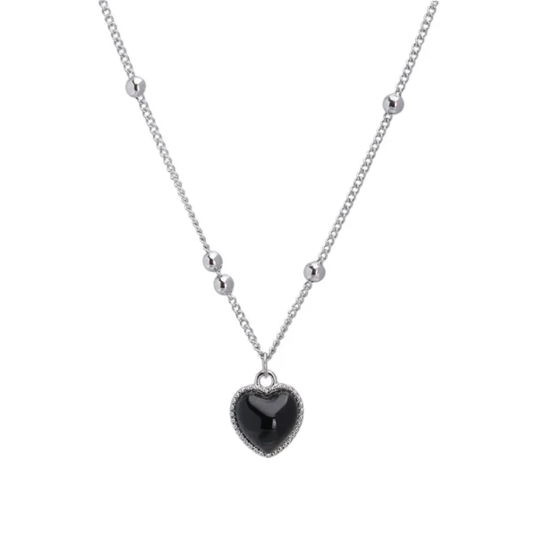 Silver necklace with black heart pendant.