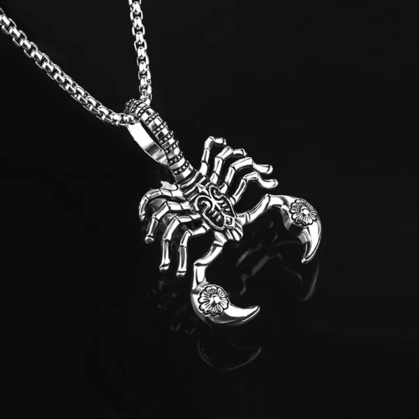 Silver scorpion pendant necklace on black background.