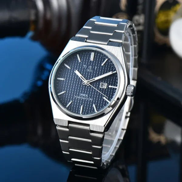 Silver Tissot wristwatch with blue face.