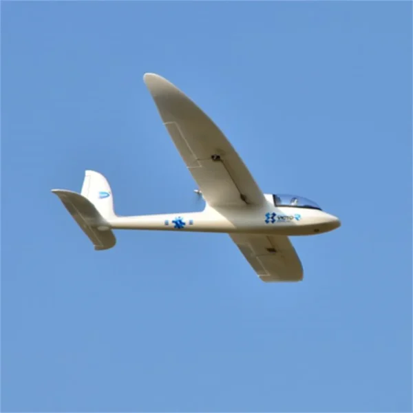 White glider plane flying in blue sky.