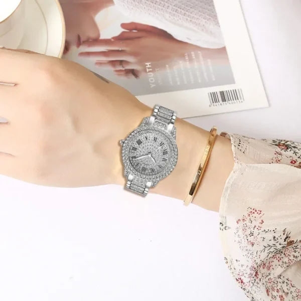 Diamond encrusted wristwatch on woman's wrist.