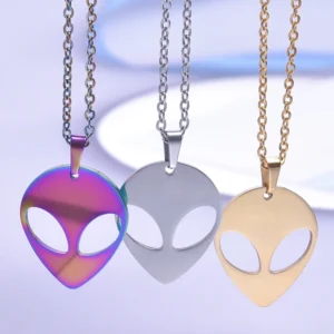 Three alien head necklaces in gold, silver, and iridescent.