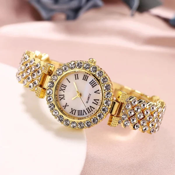 Gold jeweled quartz wristwatch with roman numerals.