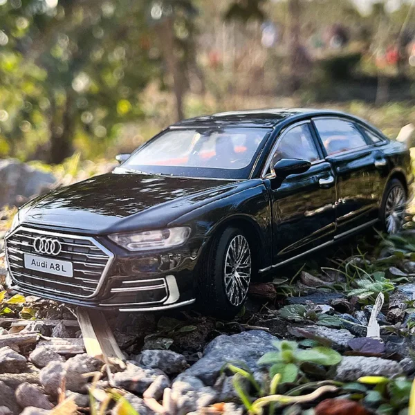 Black Audi A8L sedan on rocks.