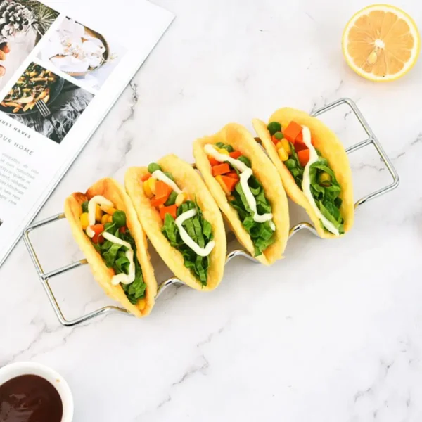 Four mini tacos with veggies and sauce.