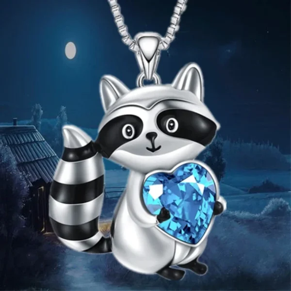 Silver raccoon charm necklace with blue heart.