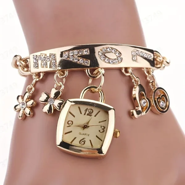 Gold charm bracelet with square watch.