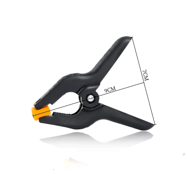 Black plastic clamp with orange handle.