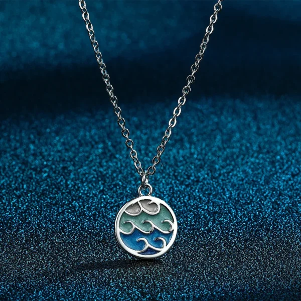 Silver necklace with ocean wave pendant.