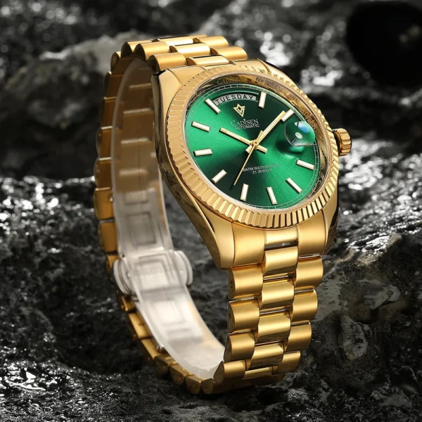 Gold automatic watch with green face.