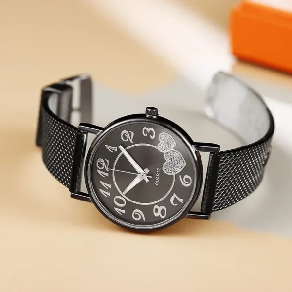 Black watch with heart design on face.