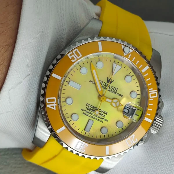 Yellow and silver diving watch on wrist.