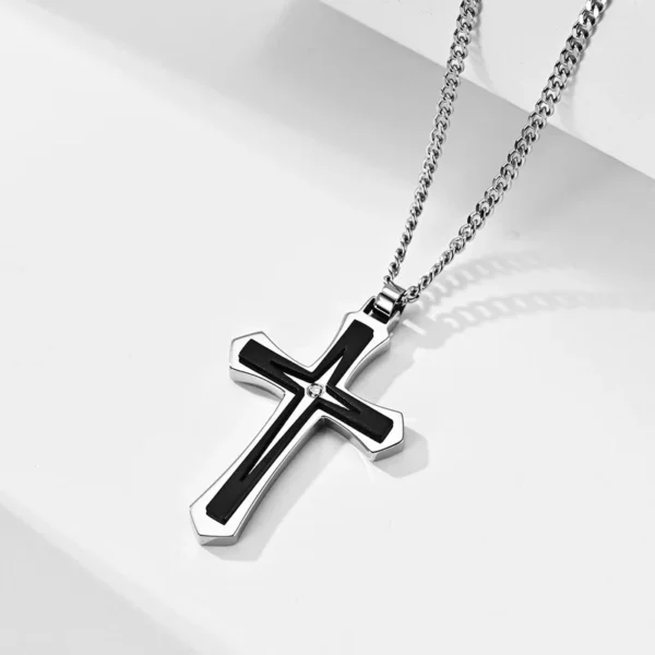 Silver chain with black cross pendant.